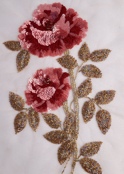 Rose motif detailing on floral cushion fabric designed for warm, expressive homes