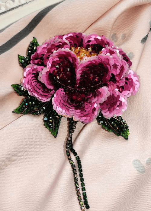 Rose motif detailing on floral cushion fabric designed for warm, expressive homes