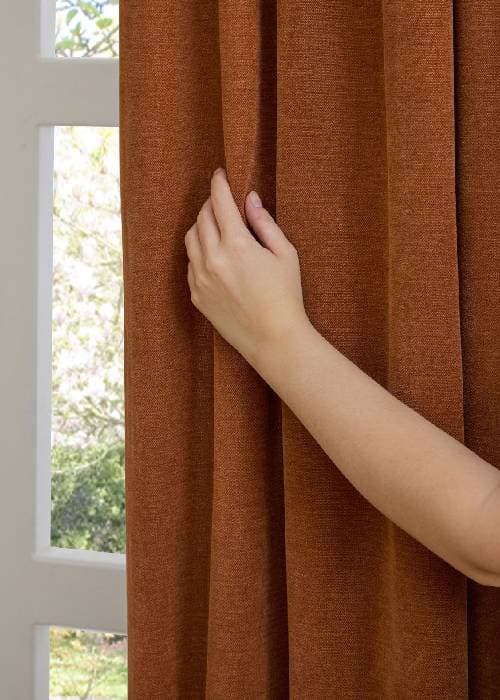 Close-up of bouclé and chenille upholstery fabric highlighting looped texture, soft pile, and tactile surface used in contemporary home furnishings.
