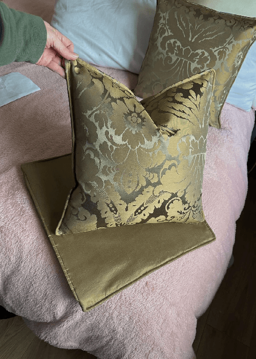 Detail of silk damask and jacquard fabric revealing intricate woven patterns, rich texture, and craftsmanship in luxury home textiles.