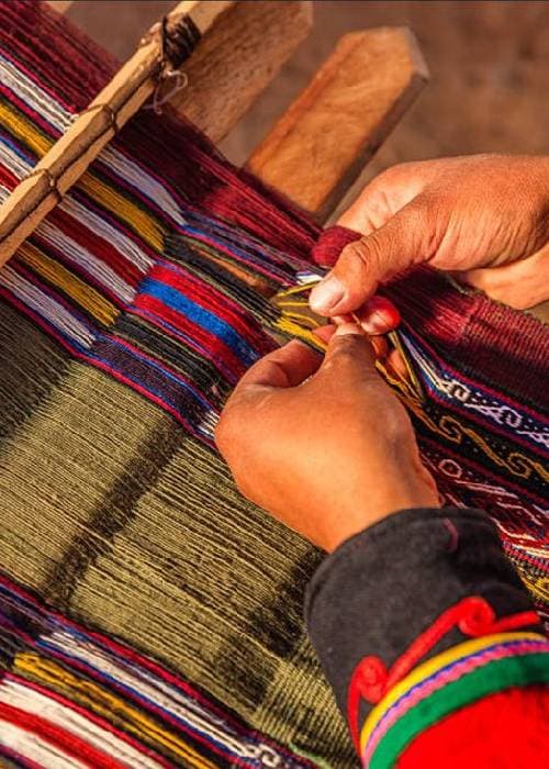 Handloom cotton fabric showcasing the subtle texture and craftsmanship of cloth woven by hand on a traditional loom.