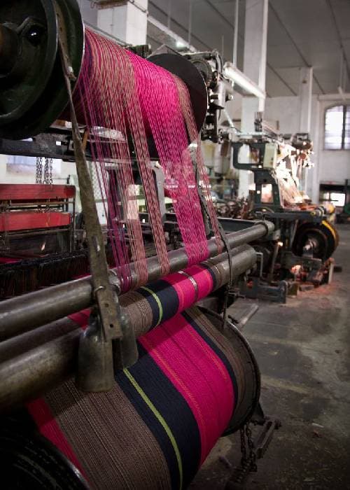 Powerloom woven fabric with a smooth, uniform texture produced using modern mechanised weaving technology.